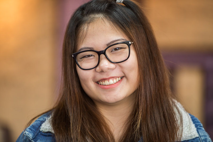 Young lady wearing glasses and smiling